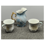Beautiful porcelain creamer and cups, light blue with a floral motif, three pieces total, see pictures for details.