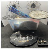 Mystery lot of assorted household items to include easy bow maker, vintage Sunshine Biscuit metal wall plate, trivet, wall decor, and more. See pictures or details.