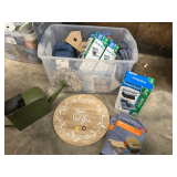 Mystery lot of household items and home decor to include a wall mount “watering can” clock, vacuum storage bags, soft sided lunch bag, and much more. Tub is not included, see pictures for details.