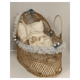 WICKER DOLL BASSINET W/ SMALL PORCELAIN DOLL 18" LONG X 15" TALL X 10" WIDE