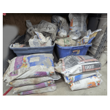 TWO TUBS AND BAGS IN FRONT OF GROUT, SAND, AND MORE