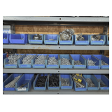 PLASTIC PARTS BINS AND CONTENTS ON THREE SHELVES MARKED 2015 INCLUDING CASTERS, DOOR STOPS, FINISHING NAILS, AND MORE