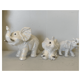 THE MARQUISE COLLECTION WHITE IRIDESCENT ELEPHANT WITH GOLD PAINTED TUSKS (ONE TUSK BROKEN) 7 1/2" LONG X 7 1/2" TALL & 2 WHITE ELEPHANTS (5 1/2" LONG X 5" TALL, 6 1/2" LONG X 4 1/4" TALL)