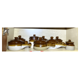 KIT… Shelf lot marked 1099 of content of top shelf, includes vintage-style stoneware soup crocks with lids and handles, and more. See pictures for details.