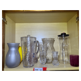KIT… Shelf lot marked 1096 of content of top shelf, includes a crystal leaf vase, believed to be Mikasa, and other assorted vases and pitchers. See pictures for details.