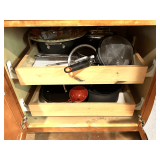 KIT… Lower cabinet lot marked 1114 of entire content of lower cabinets and drawers on both sides of kitchen. Items include assorted cookware, utensils, and more. See pictures for details.