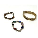 Egyptian revival scarab bracelet, vintage autumn bracelet, believed to be vintage Sarah Coventry, and a vintage gold tone metal filigree panel bracelet