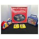Assorted Toy Collection Including Lakeside Split-Level Aggravation Board Game, G.I. Joe Lunchbox, Smurf Figure, and Famous Men & Famous Guns Sets