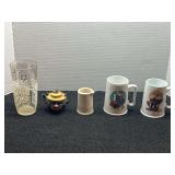 Assorted home decor to include a vintage restaurant ware creamer pitcher, Christmas mugs, vintage saltshaker, believed to be Thames red ware clown teapot salt shaker, and more. See pictures for detail