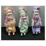 Set of Three Porcelain Pierrot Clown Dolls with Floral Fabric Outfits