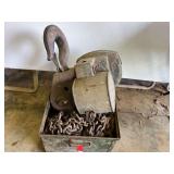 D2 –Heavy industrial rigging equipment, including steel load blocks, large forged crane hooks with safety latches, and heavy-duty load chains stored in a metal bin, see pictures for details.