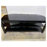 Multi-tier entertainment shelf with glass shelving.