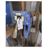 Retractable Air Hose Reel with Hose and Bars Leaning on Wall Behind