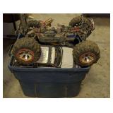 Plastic storage bin filled with electric remote control hobby car and truck parts