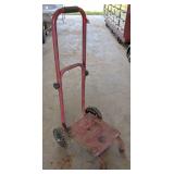 Two wheel dolly. Believed to be from a pressure washer. Handy for removing batteries and small smaller items around the shop