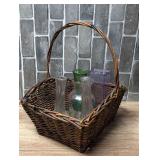 Woven Wicker Basket with Handle Containing Assorted Glass Vases