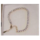 8" Gold-Tone Cubic Zirconia Tennis Bracelet With an Adjustable Extension Chain.