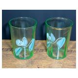 Vintage/antique hand-painted green glass tumblers with a delicate white floral motif, believed to be Victorian era or depression era glassware. Highly likely these tumblers contain uranium. Set of two