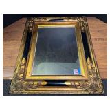 Ornate Gilt and Black Painted Wooden Wall Mirror with Scrollwork Accents