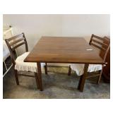 Wooden single drop-leaf dining table, with 2 matching slat-back wooden dining chairs. See pictures for details.