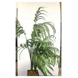 Artificial palm tree set inside a square, woven basket-style planter. See pictures for details.