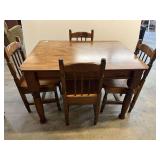 Wooden dining set with burl look surface, comes with four spindle back chairs. One chair seat is scratched, see pictures for details.