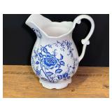 Norleans white ceramic pitcher with blue floral designs, see pictures for details.