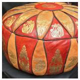 Gorgeous Hand Stitched Vintage Egyptian Revival Embossed Leather Ottoman Pouf with Gold-Foiled Historical Iconography Such as Pharaohs, Nefertiti, or Ancient Egyptian Motifs There are 2 Small Areas th
