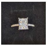 Elegant Radiant-Cut Engagement Ring with a Delicate, Shimmering Pavé-Set Diamond Band.