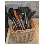BASKET FILLED WITH KITCHEN UTENSILS INCLUDING MANY MATCHING HOT TARGET