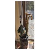 DECORATIVE UMBRELLA STAND WITH WALKING STICKS, CANES, AND UMBRELLAS