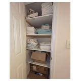 CONTENTS OF DOWNSTAIRS BATHROOM CLOSET INCLUDING BED LINENS, TOWELS, ADVANCE WALL CLOCK, MEDICAL SUPPLIES, AND MORE