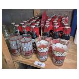 COLLECTIBLE COCA-COLA BOTTLES AND GLASSES IN SHELF SECTION MARKED 3058