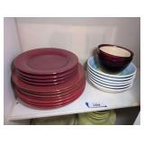 COLORFUL PLATES AND BOWLS ON SHELF MARKED 1204 INCLUDING CIAO BURGUNDY, CRATE E BARREL MADE IN ITALY, AND MORE