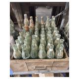 LARGE COLLECTION OF GLASS SODA BOTTLES - MANY 1950'S COKE BOTTLES