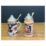 Pair of Original King German Beer Steins with Pewter Lids and Relief Scenes