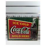 Ice cold Coca Cola sold here sign