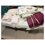 Twin sized folding rolling cot with blankets