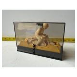 Toy motorcycle in camera case