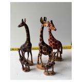 Four giraffe figurines