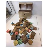 Group of wooden letter blocks with leather case