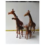 Four giraffe figurines