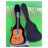 Acoustic Suzuki guitar and case