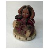 figurine depicting a Native American girl