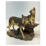figurine with a howling wolf and a cub on a rock