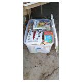 Tote with lid of assorted books and magazines