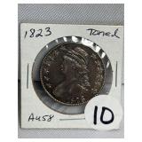 1823 Bust Toned Half -AU58