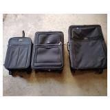 Three pieces of rolling luggage