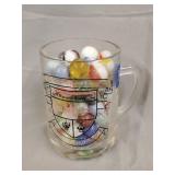 Glass mug of assorted marbles
