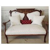 Antique settee with cushion seat, throw pillows